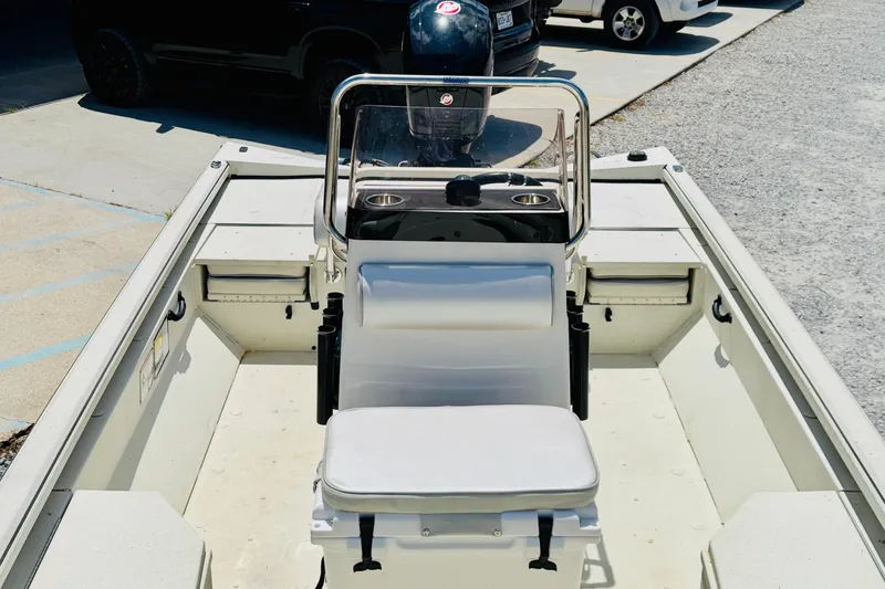 Slide: The Image of 2021 Ranger RB200 boat interior with seating and console, parked outdoors. - 8