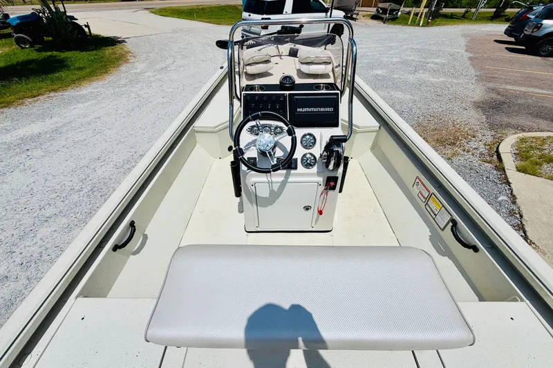 Slide: The Image of 2021 Ranger RB200 boat interior with steering console and seating, parked on gravel. - 19