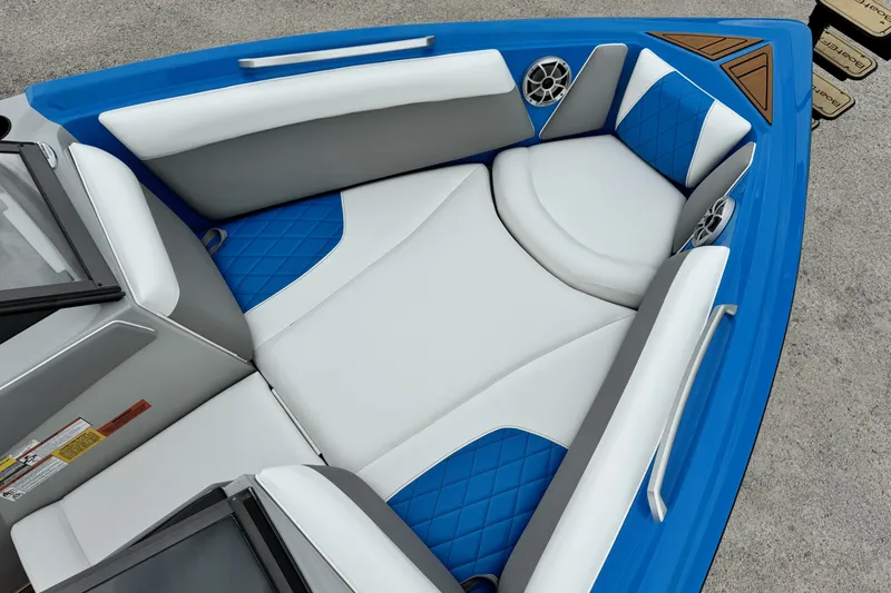Slide: The Image of 2017 Tigé R23 boat interior with blue and white seating and speakers. - 14