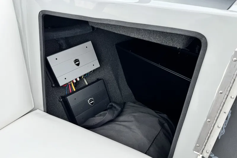 Slide: The Image of 2017 Tigé R23 boat interior storage with electronic components and wiring. - 17