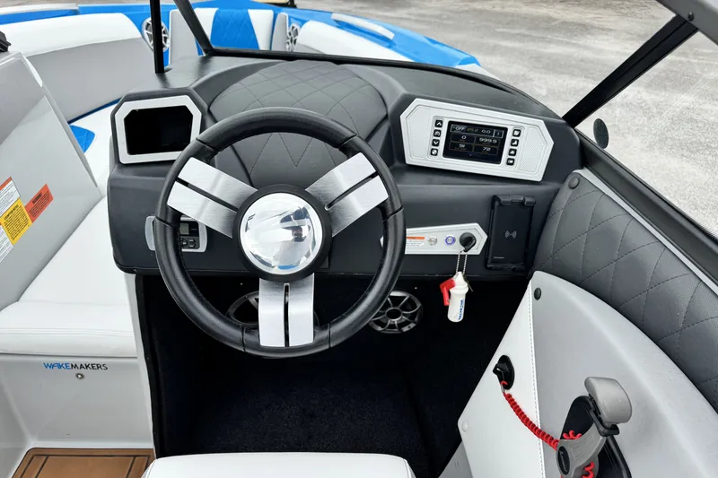 Slide: The Image of 2017 Tigé R23 boat dashboard with steering wheel and control panel. - 12