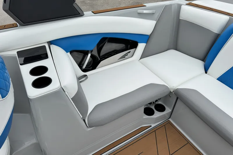 Slide: The Image of Interior of 2017 Tigé R23 boat with blue and white seating and cup holders. - 16