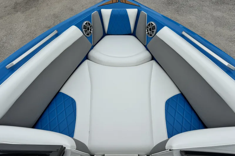 Slide: The Image of 2017 Tigé R23 boat interior with blue and white cushioned seating. - 13