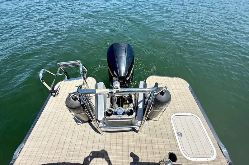 Slide: The Image of 2019 Barletta L23QC SS pontoon boat with motor on calm water. - 22