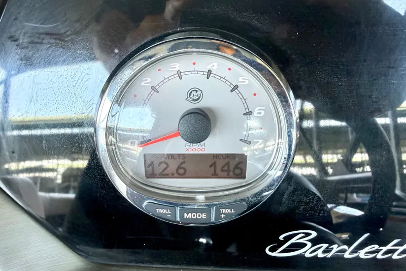Slide: The Image of Close-up of a 2019 Barletta L23QC SS boat gauge showing RPM, volts, and hours. - 31