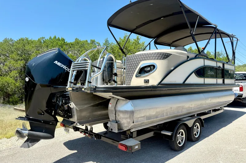 Slide: The Image of 2019 Barletta L23QC SS pontoon boat with Mercury outboard engine on trailer. - 16