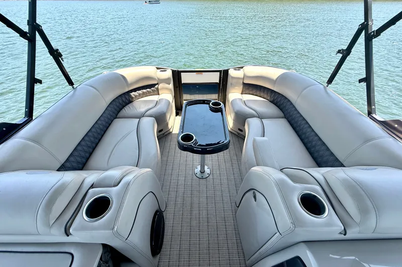 Slide: The Image of Luxurious 2019 Barletta L23QC SS pontoon boat interior with plush seating and cup holders. - 29