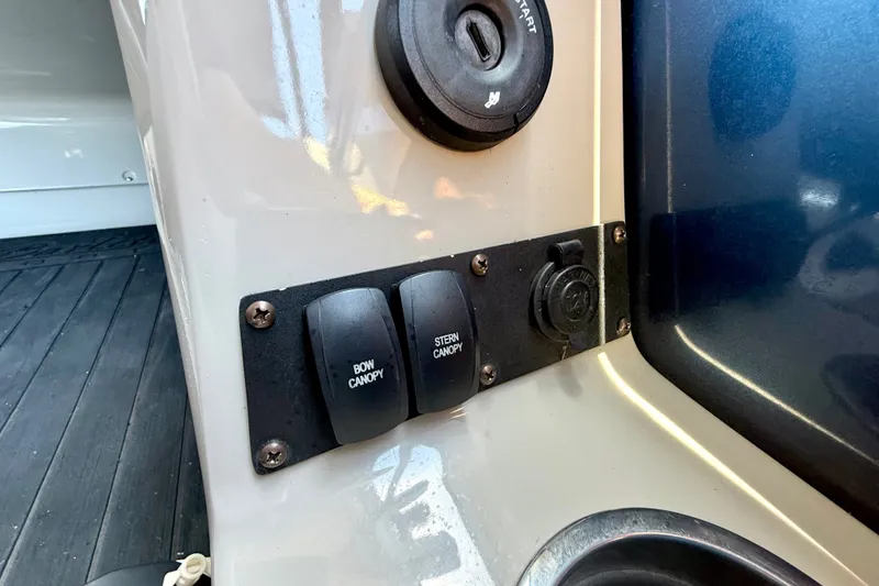 Slide: The Image of Control panel of a 2019 Barletta L23QC SS boat with canopy switches. - 26