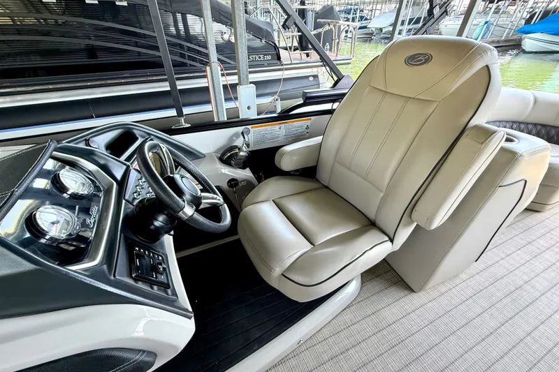 Slide: The Image of Captain's chair and dashboard of 2019 Barletta L23QC SS pontoon boat. - 41