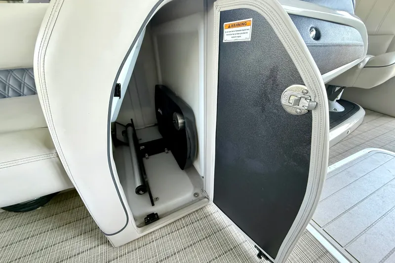 Slide: The Image of Open storage compartment in 2019 Barletta L23QC SS pontoon boat interior. - 42