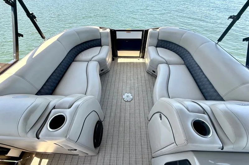 Slide: The Image of Luxurious seating on 2019 Barletta L23QC SS pontoon boat, overlooking serene water. - 20