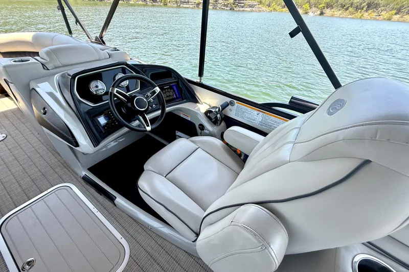 Slide: The Image of 2019 Barletta L23QC SS boat interior with steering wheel and comfortable seating. - 23