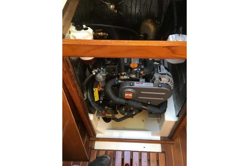 Slide: The Image of Engine compartment of a 1987 Hunter 31 sailboat, showcasing mechanical components. - 13