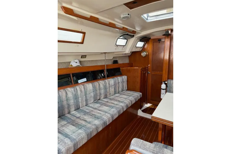Slide: The Image of Interior of a 1987 Hunter 31 sailboat with wood accents and seating area. - 6