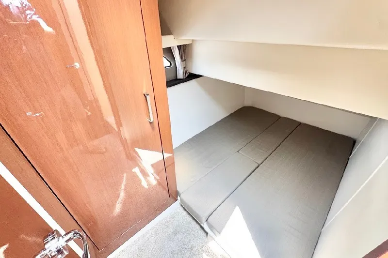 Slide: The Image of 2019 Carver C37 interior cabin with wooden cabinetry and compact sleeping area. - 25