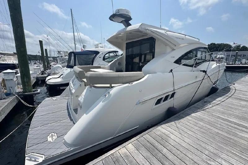 Slide: The Image of 2019 Carver C37 yacht docked at a marina under a clear sky. - 9