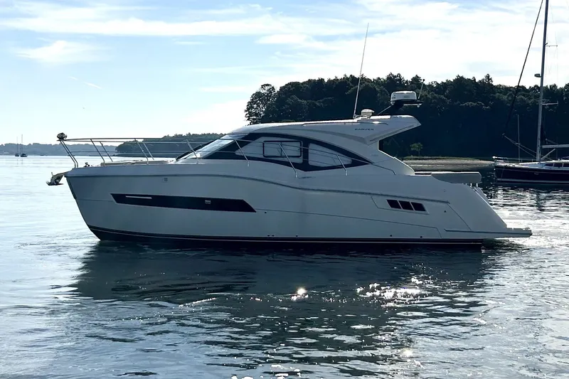 Slide: The Image of 2019 Carver C37 yacht on calm water with scenic background. - 7