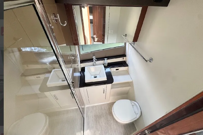 Slide: The Image of Modern bathroom interior in 2019 Carver C37 yacht, featuring sink, mirror, and toilet. - 26