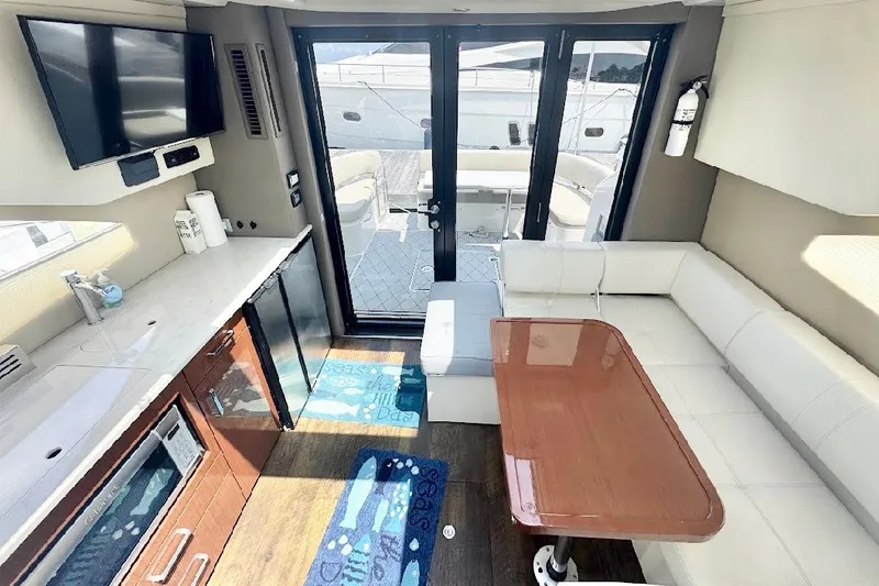 Slide: The Image of Interior of 2019 Carver C37 yacht with modern kitchen, seating, and outdoor view. - 20
