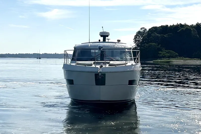 Slide: The Image of 2019 Carver C37 yacht on calm water, front view with scenic background. - 3