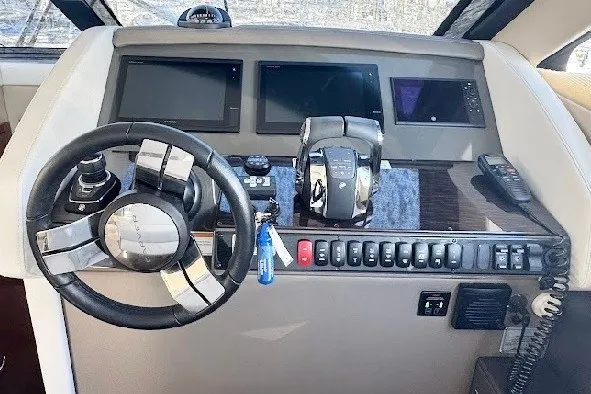 Slide: The Image of Helm of 2019 Carver C37 yacht with steering wheel, controls, and navigation screens. - 17