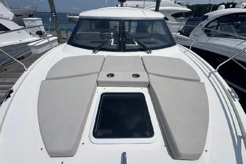 Slide: The Image of 2019 Carver C37 yacht with spacious deck and sunbathing area, docked at marina. - 12