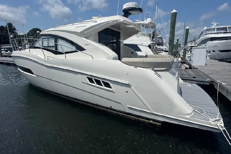 Slide: The Image of 2019 Carver C37 yacht docked at marina under clear blue sky. - 10