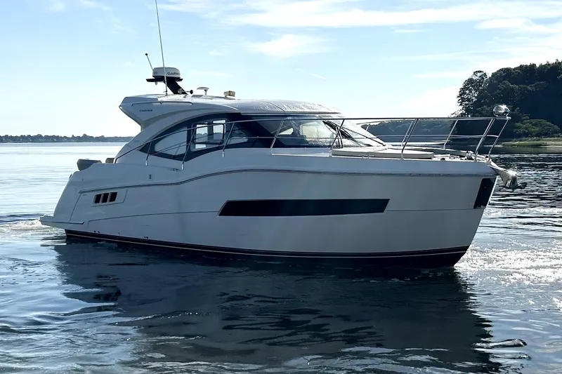 Slide: The Image of 2019 Carver C37 yacht cruising on calm waters under a clear blue sky. - 1
