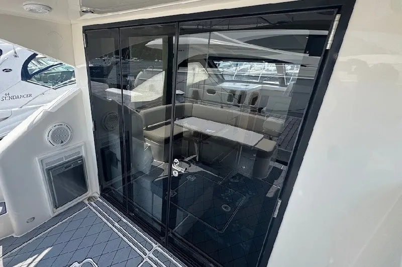 Slide: The Image of 2019 Carver C37 yacht interior with glass doors and seating area. - 23