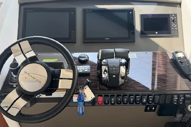 Slide: The Image of 2019 Carver C37 helm with steering wheel, dual screens, and control panel. - 14