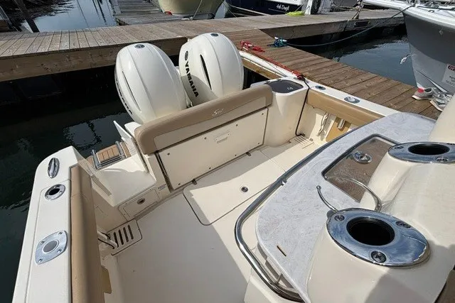Slide: The Image of 2021 Scout 255 LXF boat interior with dual Yamaha engines at dock. - 15