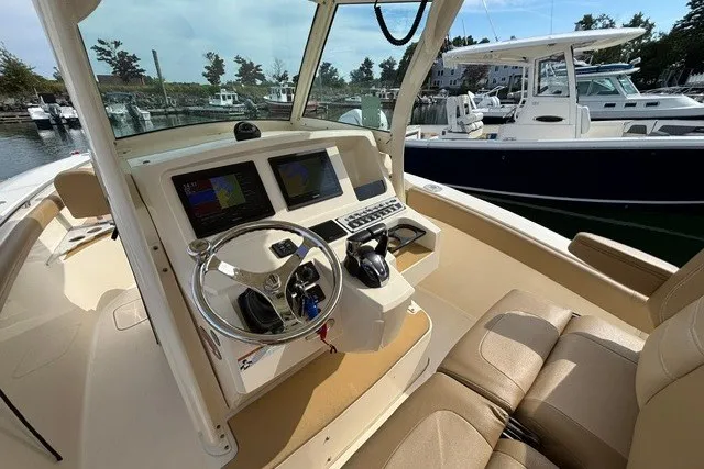 Slide: The Image of 2021 Scout 255 LXF boat interior with modern dashboard and steering wheel. - 6