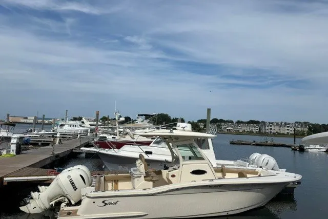 The Image of 2021 Scout 255 LXF boat docked at marina with Yamaha engines. - 0