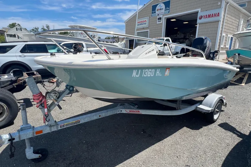 The Image of 2019 Boston Whaler 130 Super Sport boat on trailer, parked outside marina. - 0