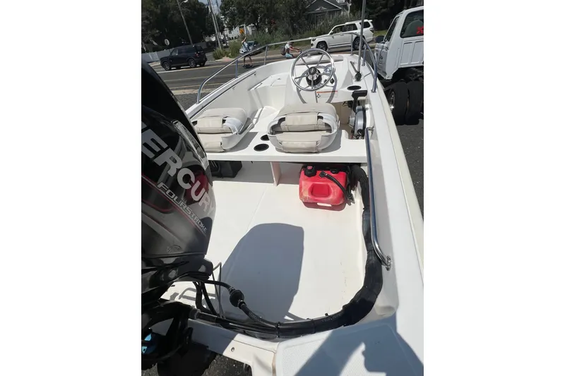 Slide: The Image of 2019 Boston Whaler 130 Super Sport boat interior with Mercury engine and seating. - 4