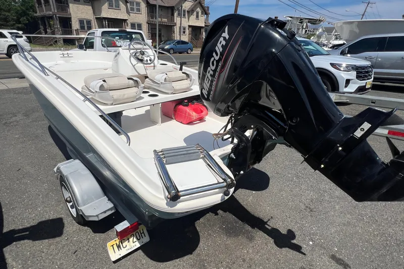 Slide: The Image of 2019 Boston Whaler 130 Super Sport boat with Mercury engine on trailer. - 2
