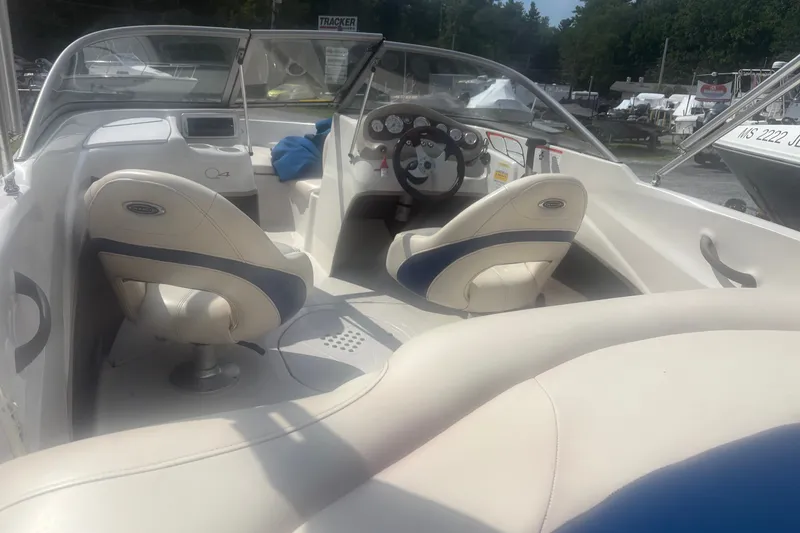 Slide: The Image of Interior of a 2011 Tahoe Q4 SF boat with white and blue seating. - 7