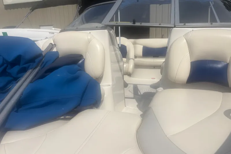 Slide: The Image of 2011 Tahoe Q4 SF boat interior with white and blue seating, featuring a windshield and blue cover. - 6