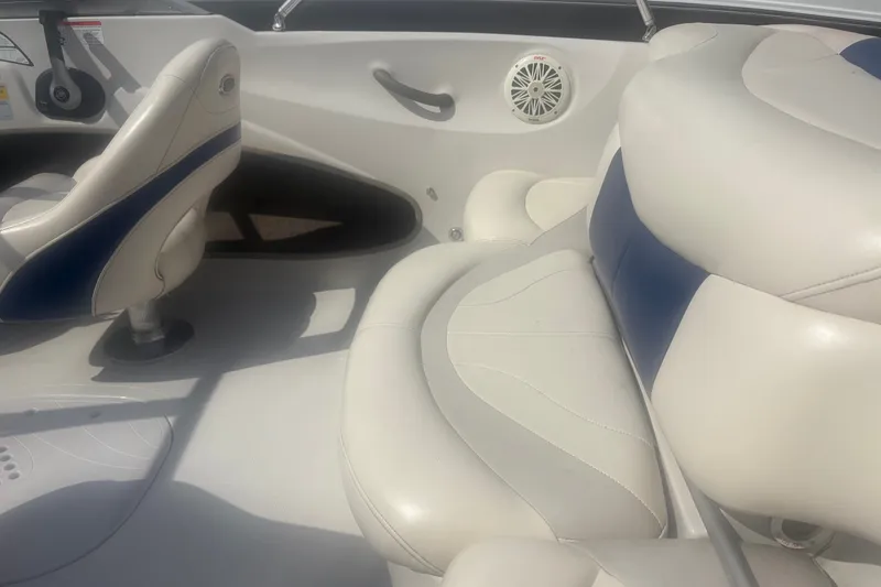 Slide: The Image of Interior of a 2011 Tahoe Q4 SF boat with white and blue seating. - 4