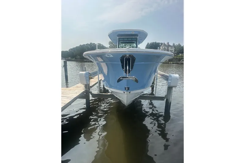 Slide: The Image of 2024 Blackfin 272 CC boat docked on a sunny day, front view. - 5