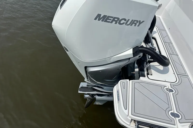 Slide: The Image of 2024 Blackfin 272 CC boat with Mercury outboard motor on water. - 9