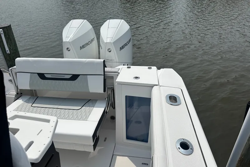 Slide: The Image of 2024 Blackfin 272 CC boat with twin Mercury engines on calm water. - 15
