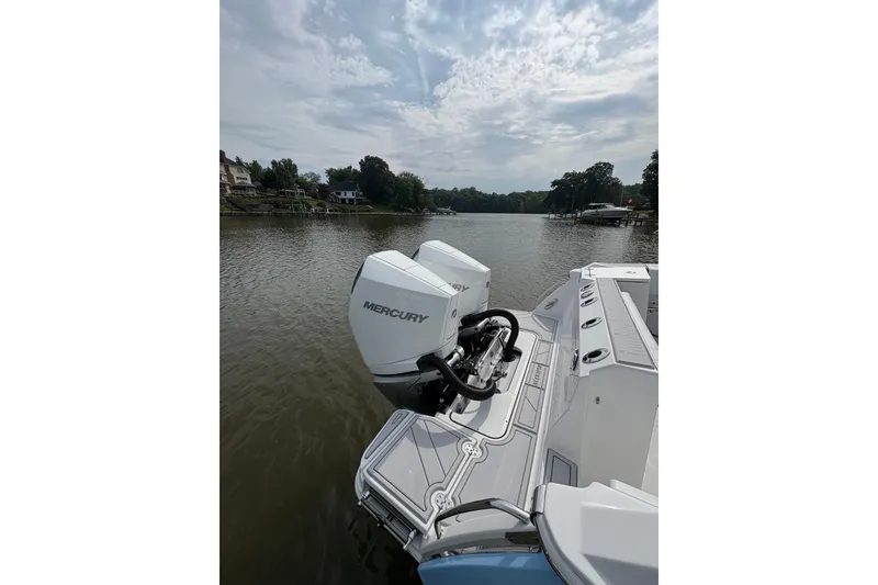 Slide: The Image of 2024 Blackfin 272 CC boat with Mercury engines on a calm lake. - 8