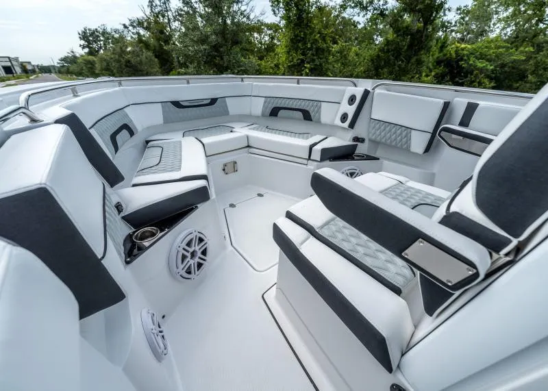 Slide: The Image of The image shows the cockpit of a 2024 Blackfin 272 CC boat with sleek white and gray upholstery. - 32