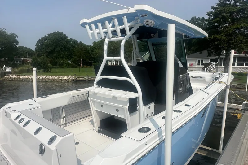 Slide: The Image of 2024 Blackfin 272 CC boat docked, showcasing sleek design and spacious deck layout. - 6