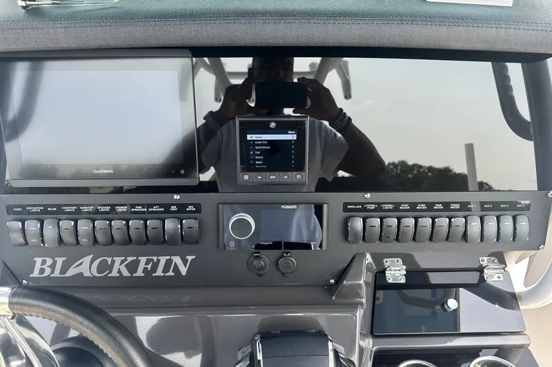 Slide: The Image of 2024 Blackfin 272 CC dashboard with Garmin display and control switches. - 23