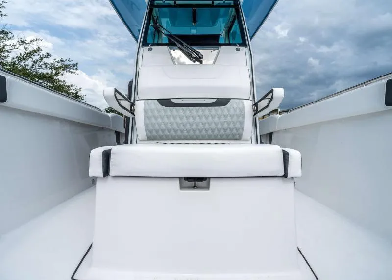 Slide: The Image of The image shows the cockpit of a 2024 Blackfin 272 CC boat with white upholstery. - 30