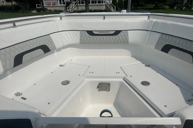 Slide: The Image of 2024 Blackfin 272 CC boat interior with white seating and storage compartments. - 35