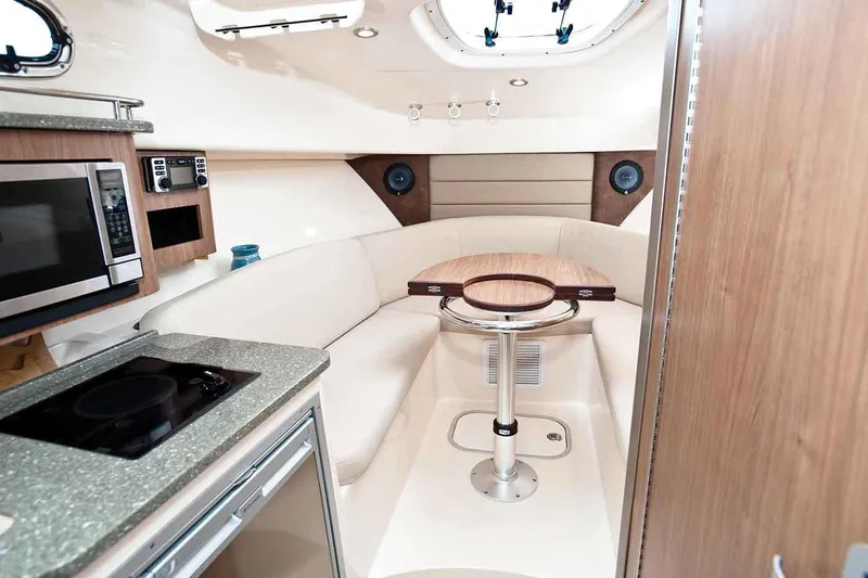 Slide: The Image of Manufacturer Provided Image: Interior of 2020 Boston Whaler 285 Conquest with kitchen and seating area. - 4