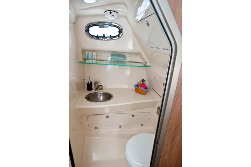 Slide: The Image of Manufacturer Provided Image: 2020 Boston Whaler 285 Conquest boat bathroom with sink, toilet, and storage. - 5